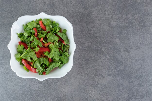 Bowl of fresh salad on marble background. High quality photo