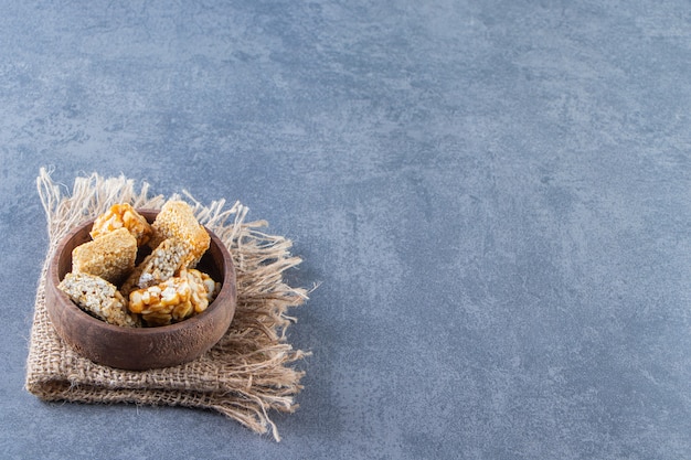 A bowl of granola bars in a texture , on the marble background.