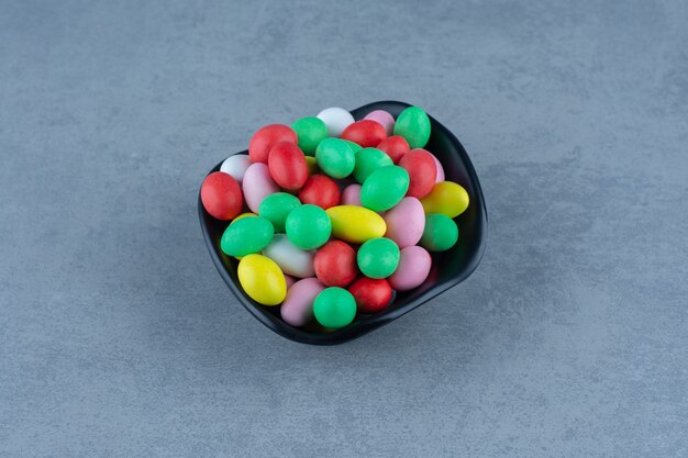 A bowl of mixed gums, on the marble table. 