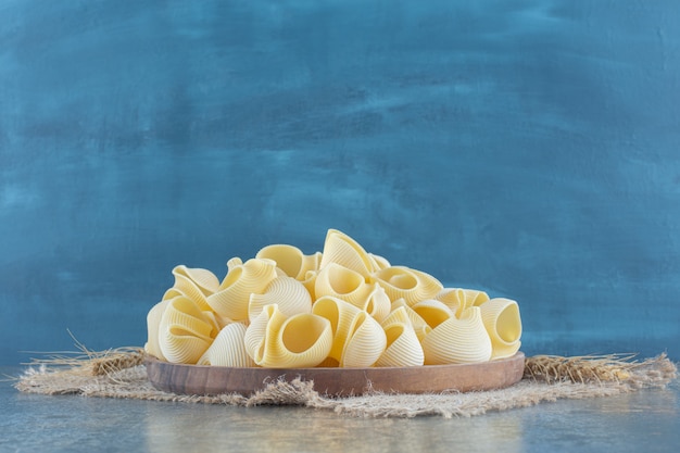 A bowl of mixed pasta , on the marble surface.