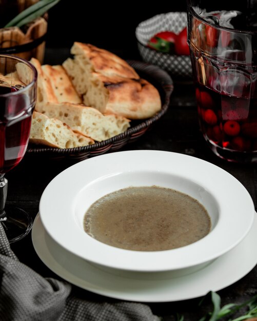 bowl of mushroom soup served with tandoor bread