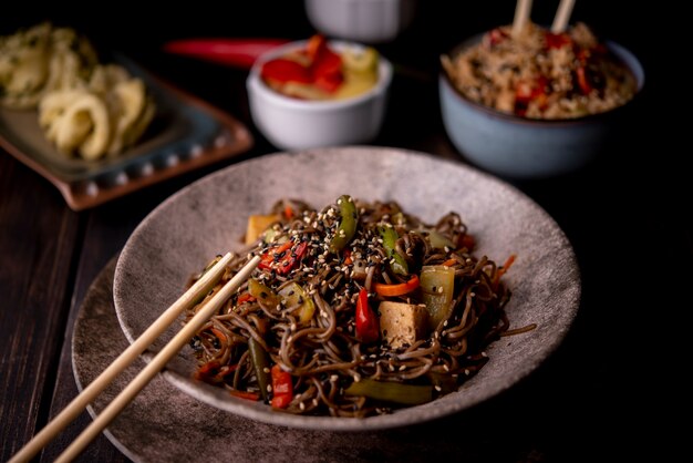 Bowl of noodles with assortment of asian food