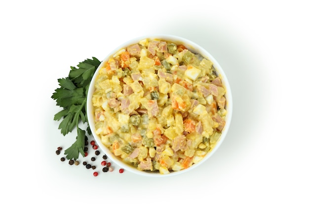 Bowl of olivier salad isolated on white background
