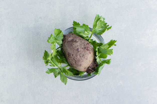 A bowl of radish with parsley , on the marble.