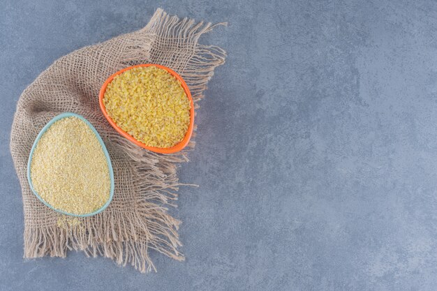 A bowl of rice on the towel, on the marble background. 