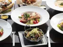 Free photo bowl of salmon fish with vegetables on a wooden surface