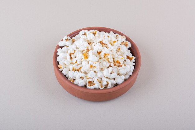 Bowl of salted popcorn for movie night on white background. High quality photo