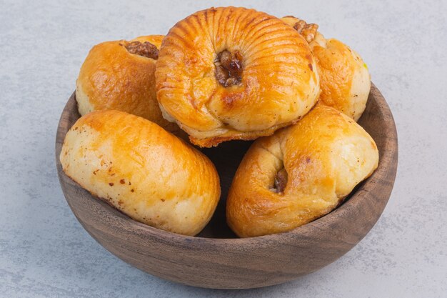 A bowl of sweet cookies, on the marble.