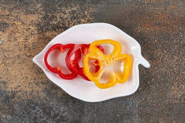 A bowl of sweet pepper  on the marble surface