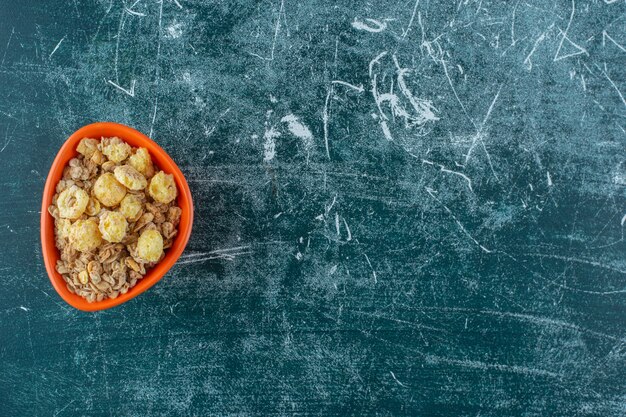 A bowl of tasty cereal on a , on the blue background. High quality photo