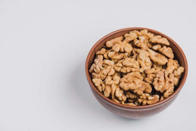 Bowl of walnuts on white