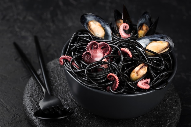 Bowl with black past and sea food