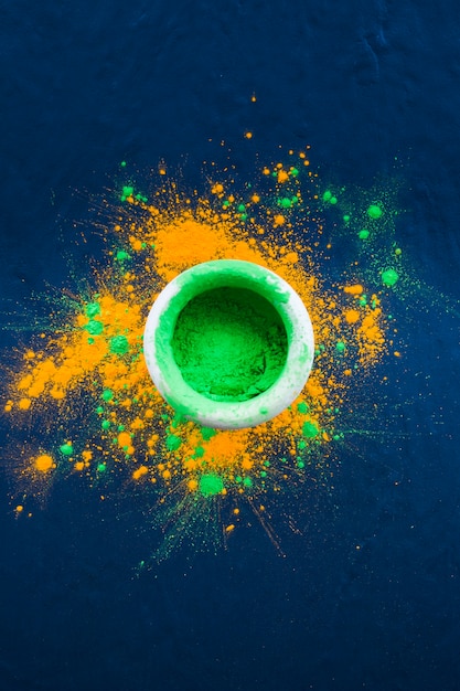 Bowl with bright green powder on table