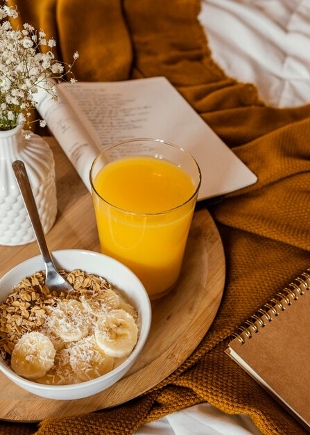 Bowl with cereal and banana slices high angle