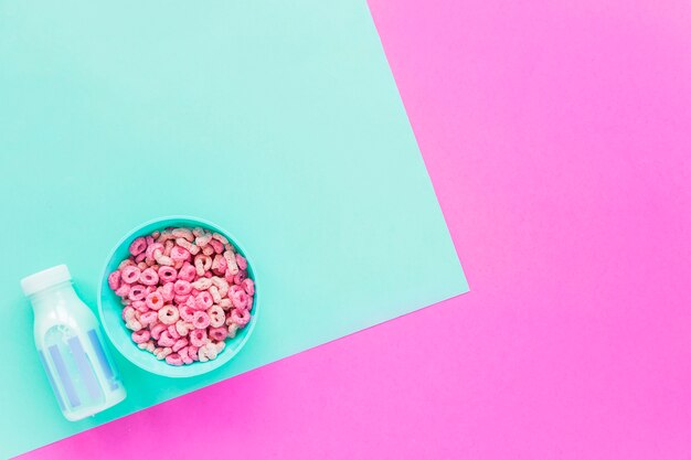 Bowl with cereals and blue milk bottle