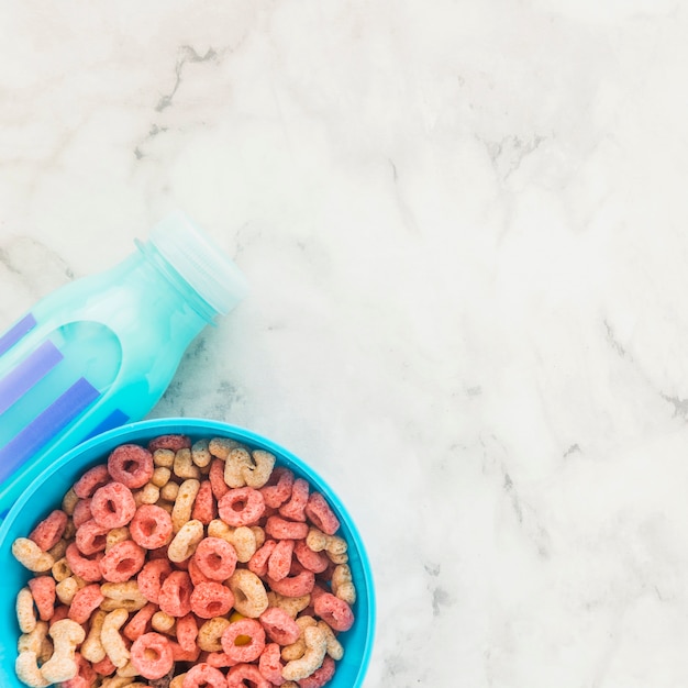 Free photo bowl with cereals and bright milk bottle