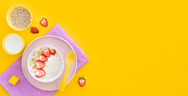 Bowl with cereals and fruits with copy-space