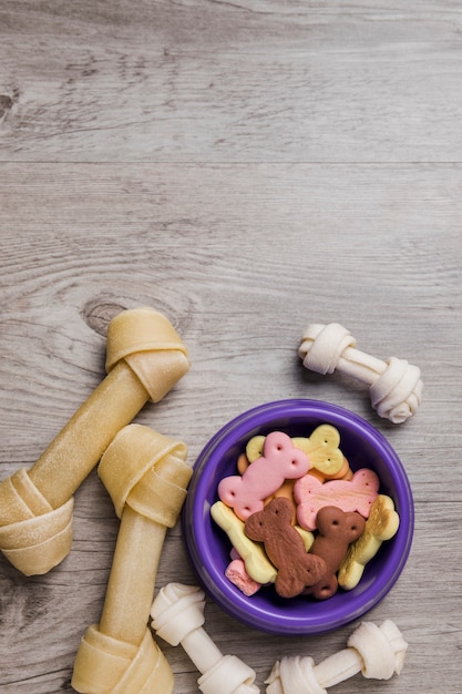 Bowl with dog snacks on floor