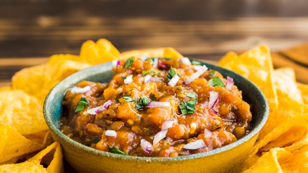 Bowl with garnish near nachos