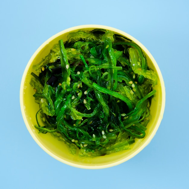 Bowl with green seaweed salad