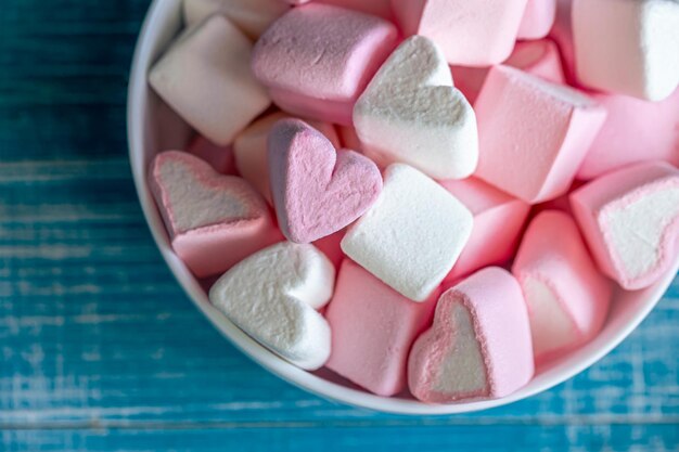 Free photo bowl with marshmallows in the form of hearts closeup top view