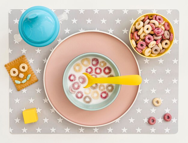 Bowl with milk and cereals on table