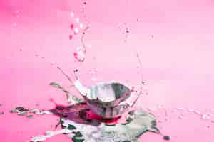 Free photo bowl with mixed paint and pink background