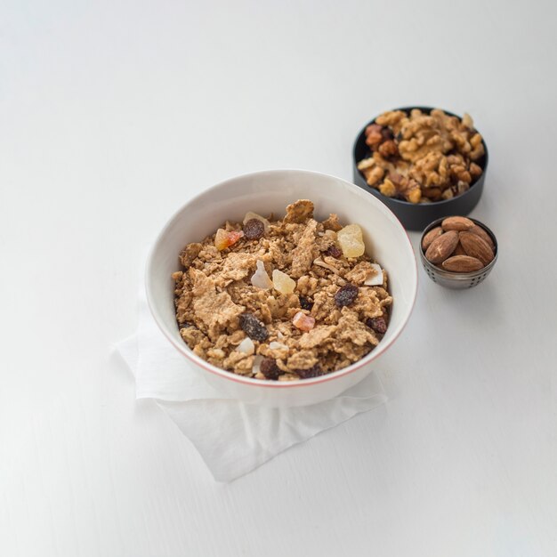 Bowl with muesli near nuts