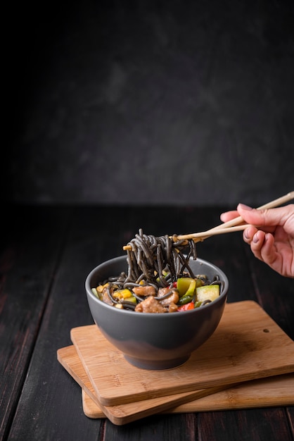 Free photo bowl with noodles and chopsticks