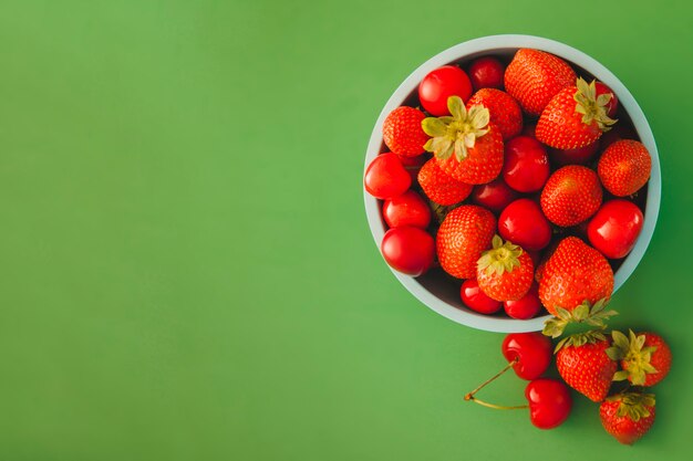 Bowl with red fruits with copy space