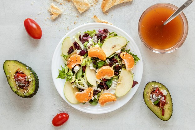 Bowl with salad and avocado beside