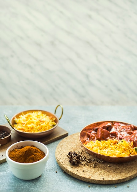 Bowl with spice powder near rice dishes