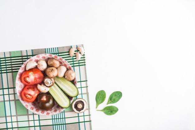 Bowl with vegetables on napkin