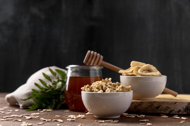 Bowl with yougurt and granola cereals with honey