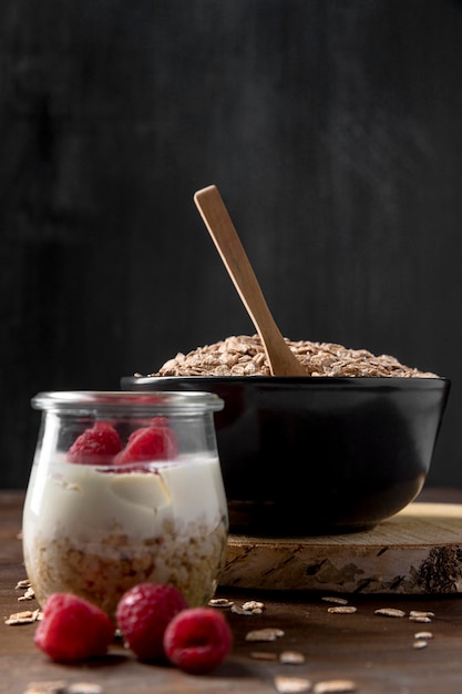 Bowl with yougurt with granola cereals on desk