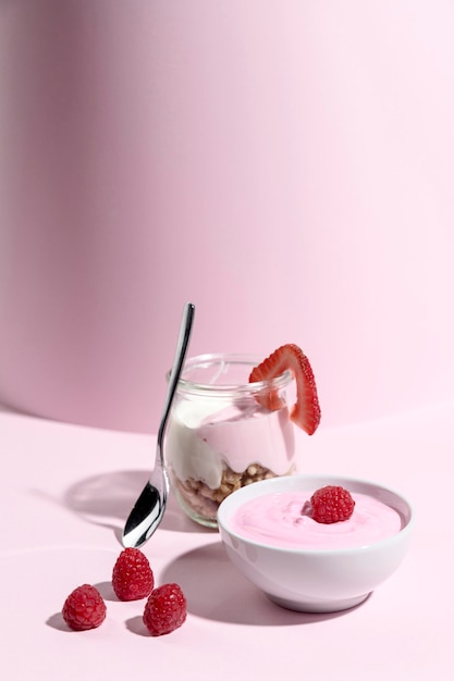 Bowl with yougurt with raspberry on table