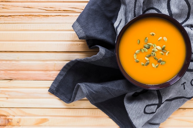 Free photo bowl with yummy soup on towel