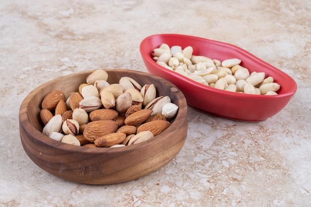 Bowls of almonds, pistachios and  peanuts