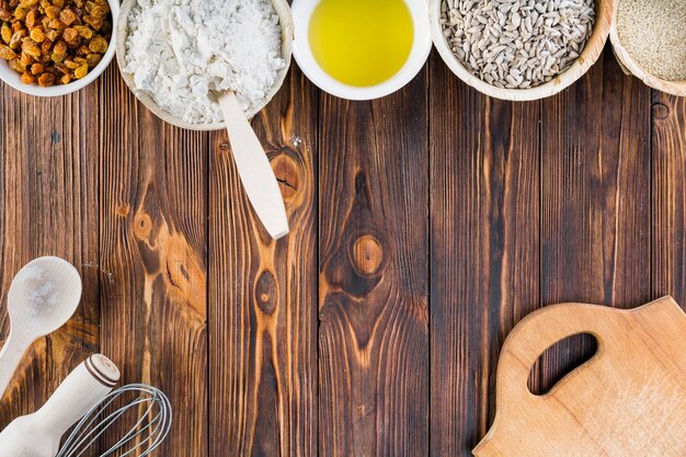 Bowls of baking ingredients on dark wooden table