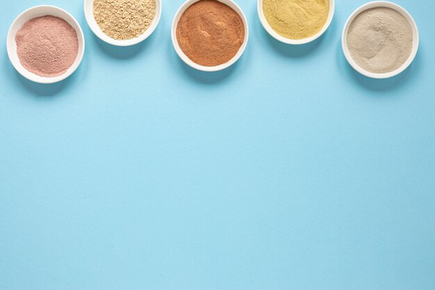 Bowls filled with coloured sand copy space