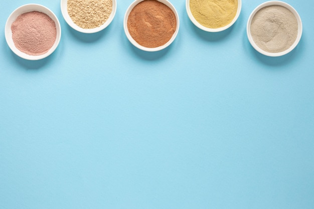 Bowls filled with coloured sand copy space