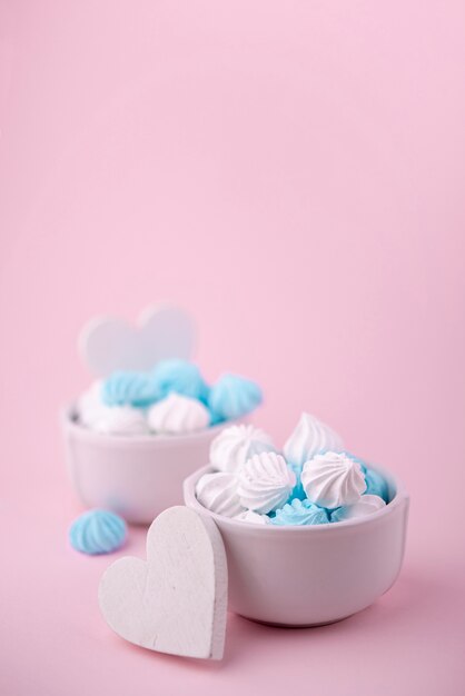 Bowls of meringue with hearts and copy space
