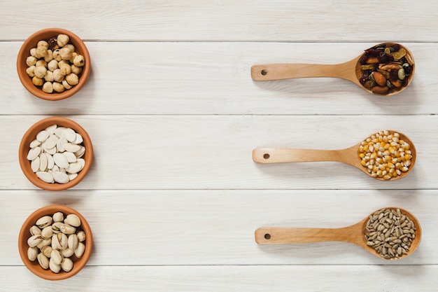 Bowls and spoons with seeds and nuts