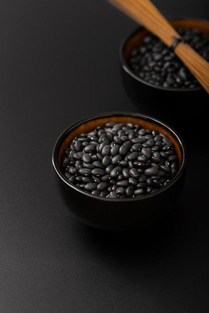 Free photo bowls with beans on a dark background