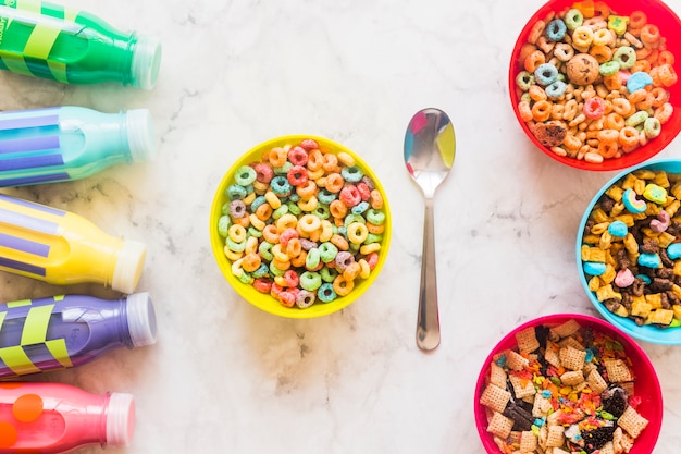 Bowls with cereals and milk bottles on table 