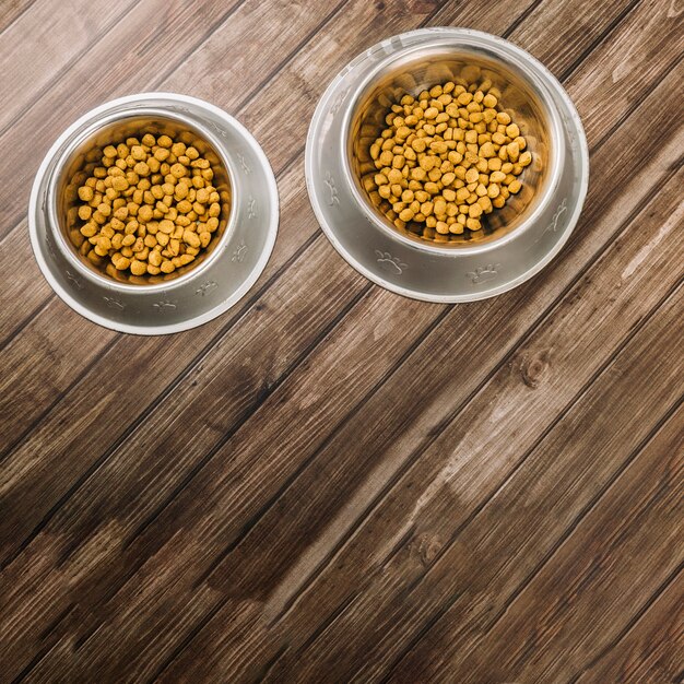 Bowls with pet food on floor