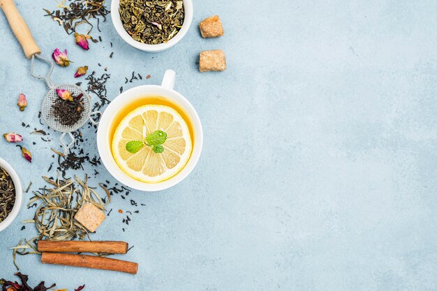 Bowls with tea herbs and lemon tea