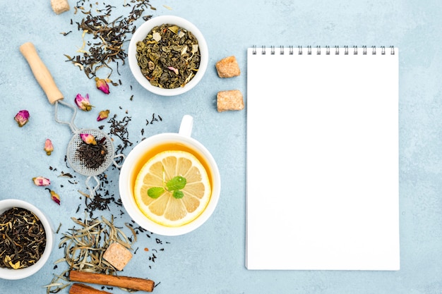 Bowls with tea herbs with notebook