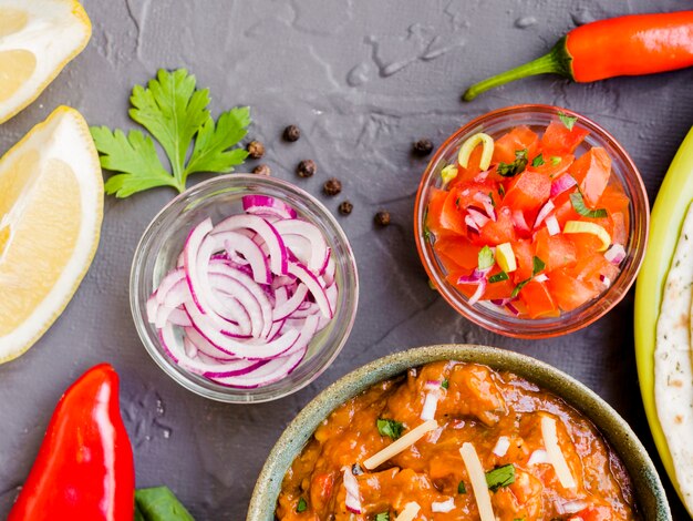 Bowls with vegetables and cup of garnish