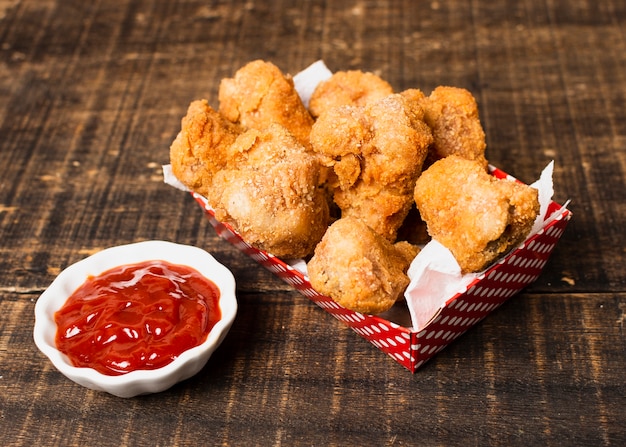 Box of fried chicken with ketchup